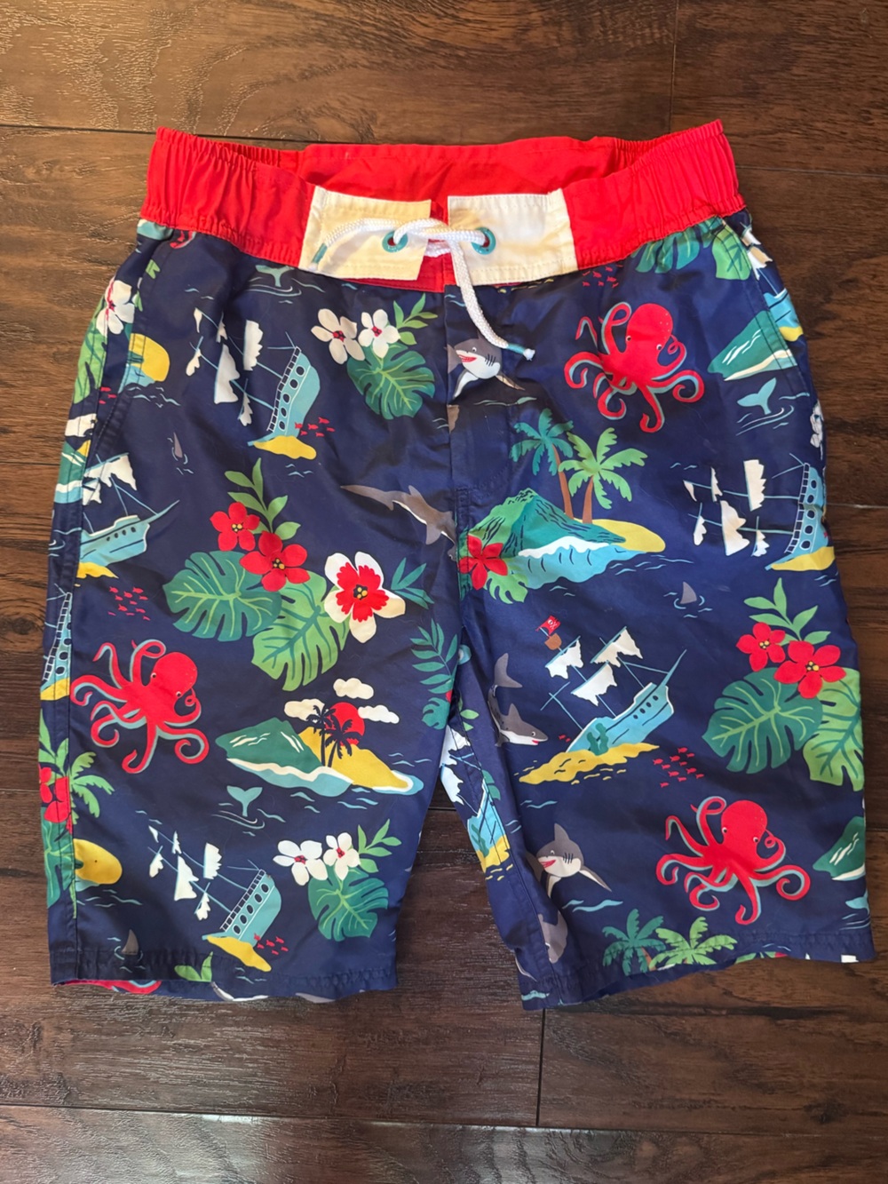 Mini Boden Navy Swim Trunks with Red Waistband and Tropical Print 13/14